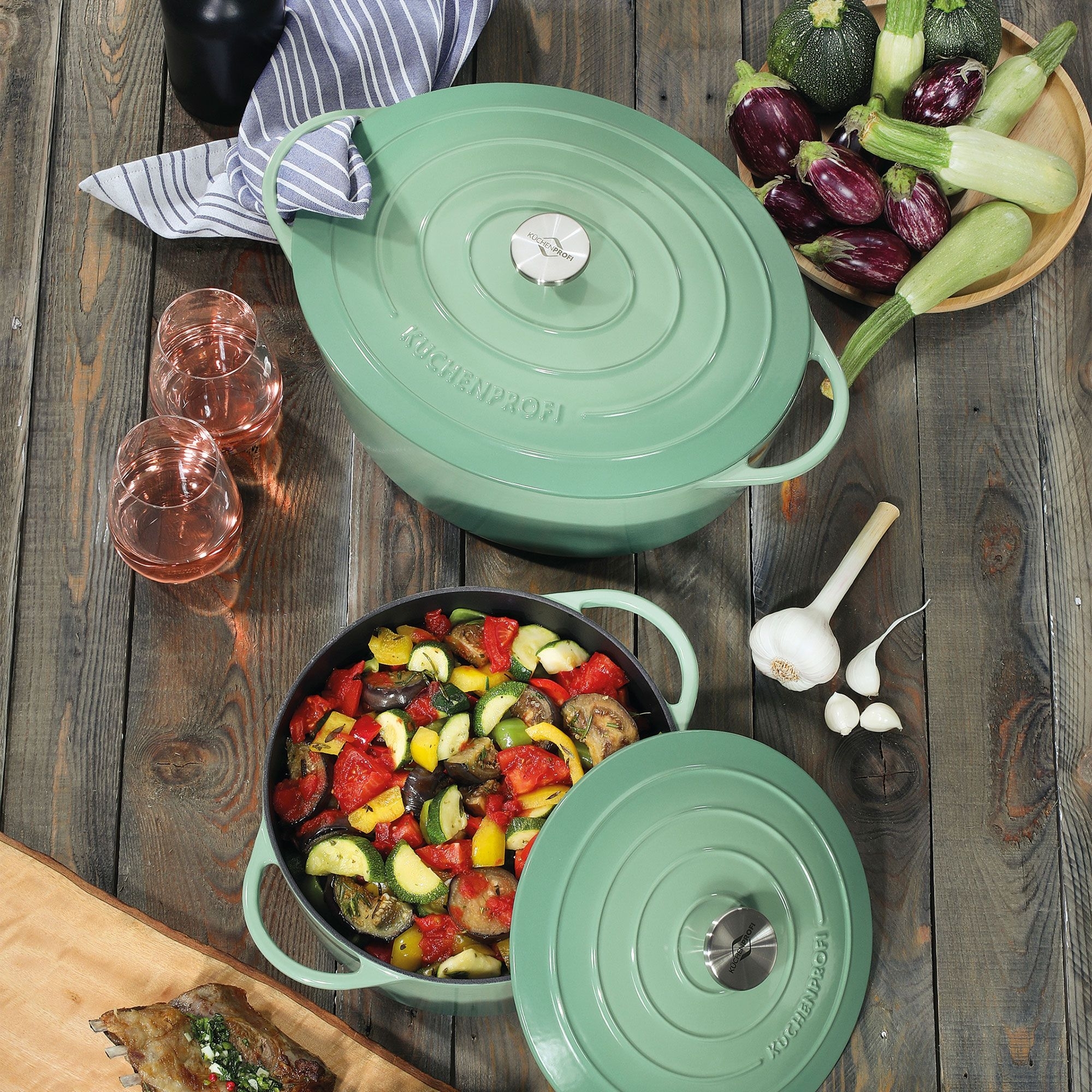 Green enamel casserole filled with baked vegetables